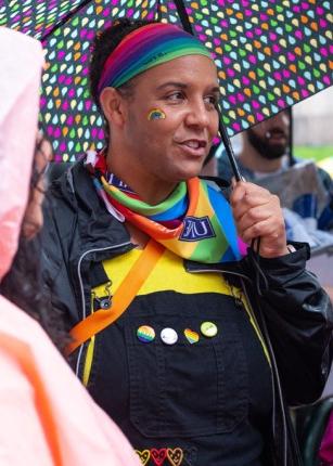 在波特兰同志游行中，一名戴着彩虹发带和大手帕的大学生