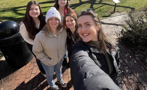 A group of UNE students and faculty take a selfie in front of Philadelphia's Independence Hall